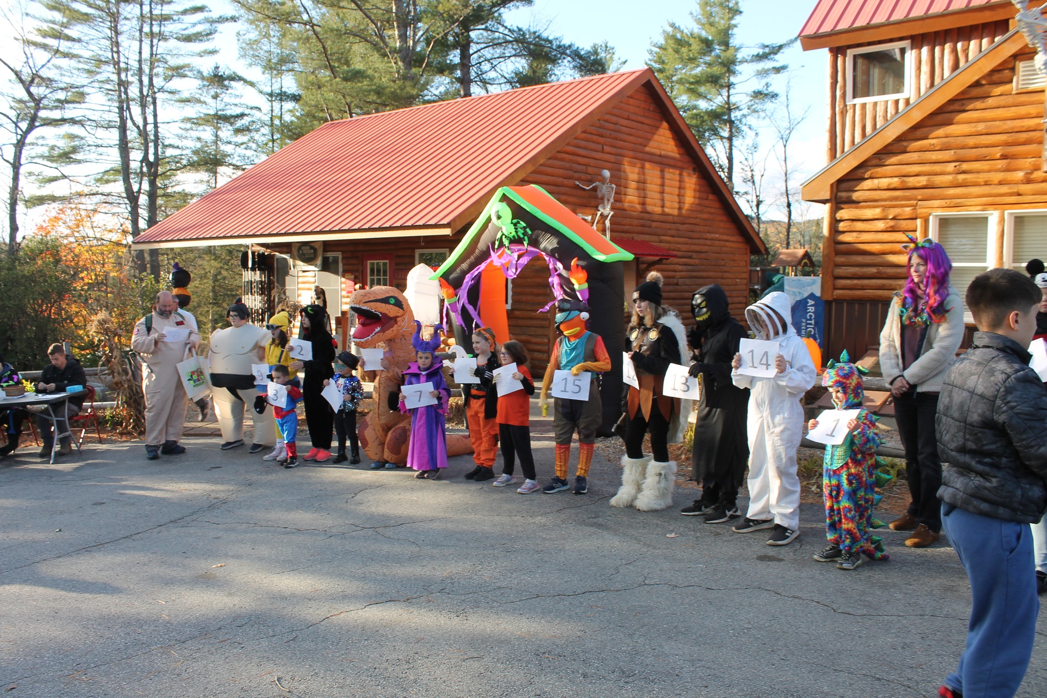 Children in Halloween costumes line up for a contest.