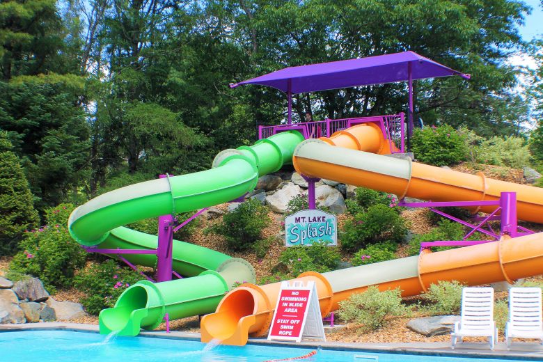 Mt. Lake Splash water slides with green and orange tubes leading to a pool.