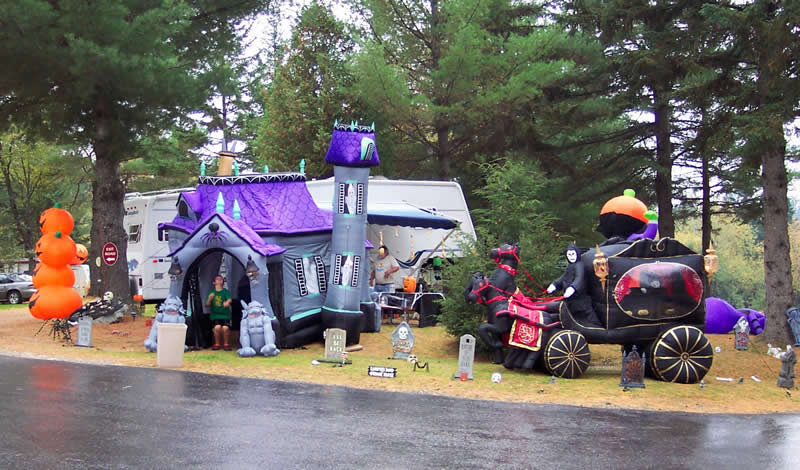 Inflatable Halloween decorations: haunted house, pumpkin stack, and carriage.